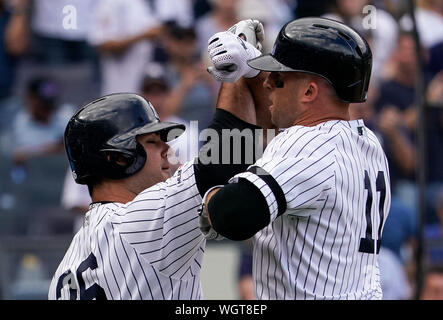 New York Yankees on-deck batter Erik Kratz (38) celebrates with teammate  Thairo Estrada, right, after Estrada hit a solo home run during the fourth  inning of a baseball game, Monday, Aug. 17