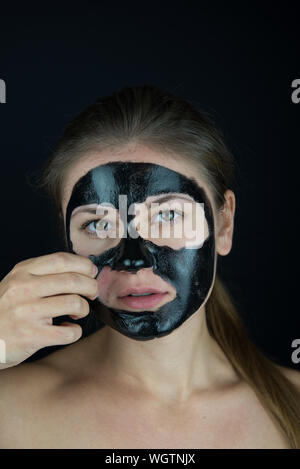 Download Young Woman Removing Facial Mask Reflecting On Mirror Stock Photo Alamy PSD Mockup Templates