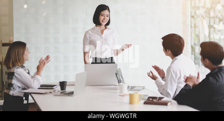 Young professional businesswoman presenting her idea about the project to her team member in the meeting room Stock Photo