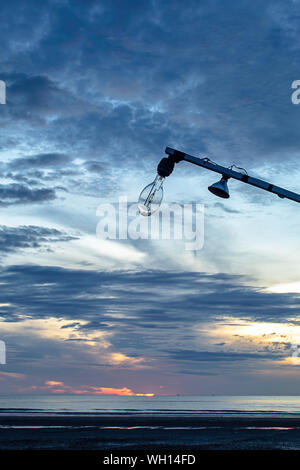 The morning sun light in the sea and light bulb on wood. Stock Photo
