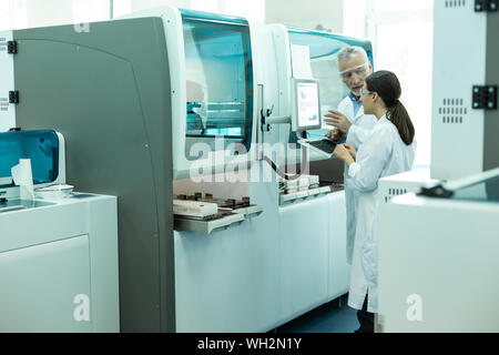 Handsome mature man talking to his assistant Stock Photo