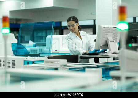 Cheerful medical worker testing new computer program Stock Photo