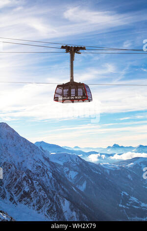 Chamonix Mont Blanc, France - January 28, 2015: Cable Car from Chamonix to the summit of the Aiguille du Midi and mountains panorama Chamonix, France. Stock Photo