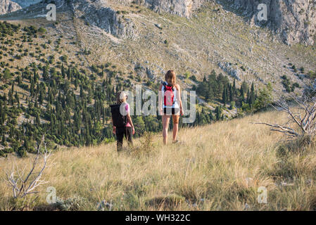 Two women enjoy hiking on the beautiful day at Velez mountain ,near Mostar in Bosnia and Herzegovina Stock Photo
