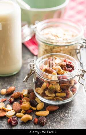 Mix of various nuts and raisins in jar. Stock Photo