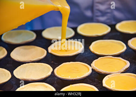 Pasteis de Nata, traditional Portuguese pastries, being made in a Lisbon bakery Stock Photo