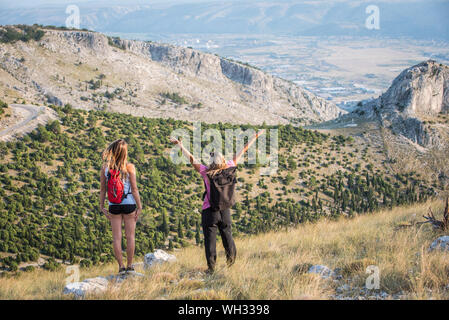 Two women enjoy hiking on the beautiful day at Velez mountain ,near Mostar in Bosnia and Herzegovina Stock Photo