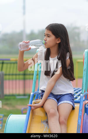 Asian girls drink bottled water.