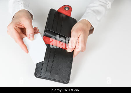 Woman hand hold and bring out card in her purse Stock Photo