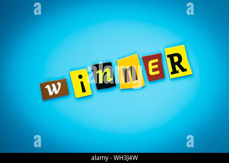 Single word - winner. Text on blue background from colorful letters. Message on poster. Headline on card. Colored inscription on banner. Stock Photo