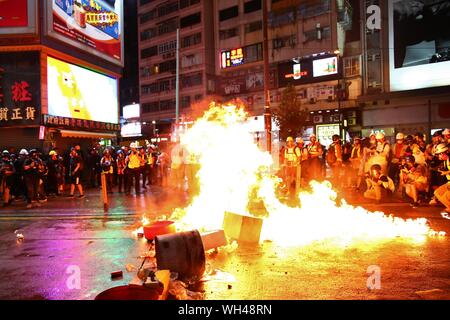 Hong Kong, China. 31st, August 2019. Riots escalates in different districts after the unauthorized peaceful rally. Protesters drop petrol bombs in front of Causeway Bay MTR station. Stock Photo