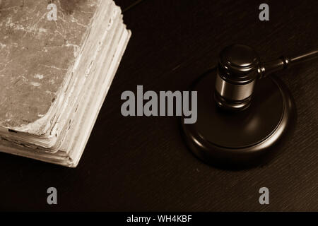 Judge gavel beside pile of books on black wooden background Stock Photo ...