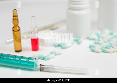 Medical syringe with medicine pill and vials Stock Photo