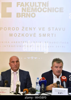 University Hospital Brno doctors have delivered the child of a mother who suffered brain death in the 16th week of pregnancy after 117 days of keeping the mother's body alive, the doctors detailed the August 15 procedure at a press conference on September 2, 2019, in Brno, Czech Republic. On the photo are seen L-R CEO of the Health Insurance in Czech Republic (VZP) Zdenek Kabatek and Director of the hospital Roman Kraus. The doctors noted that the case shows the immense strength of the baby, named Eliska by the mother at the start of her pregnancy, as well as the mother's body. With the doctor Stock Photo
