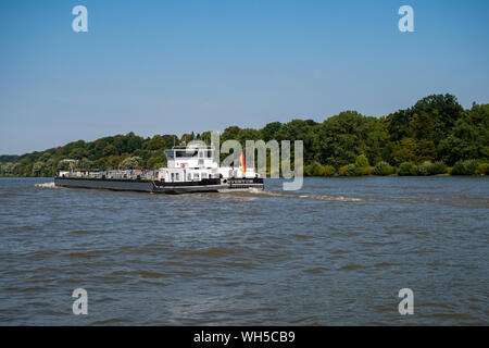 Hamburg, Germany - August 25, 2019 : View from crossing ferry at rear of tanker Eventum driving on the Elbe River at day. Eventum is owned by Gausch T Stock Photo