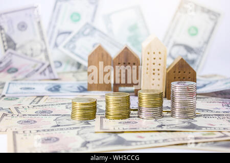 Stacked Coins With Model Houses And Paper Currencies