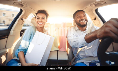 Afro couple driving home after shopping in mall Stock Photo