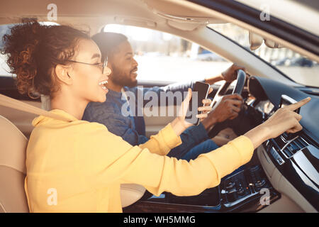 Road trip. Couple driving car and using gps navigator Stock Photo