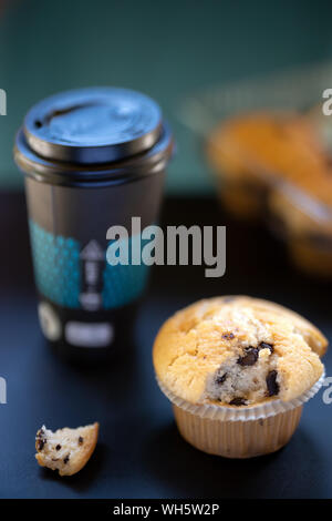 Chocolate muffin and coffee cup to go. Muffins and coffee Stock Photo