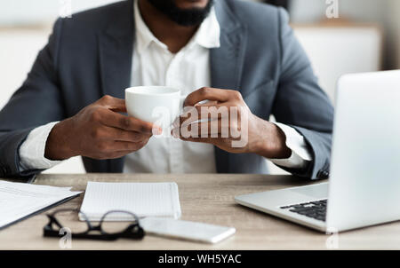 African american businessman drinking coffee at workplace Stock Photo