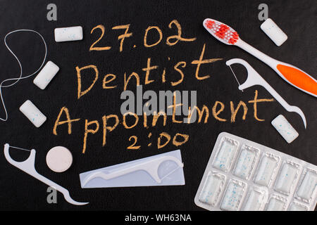 Dentist appointment reminder on chalkboard. Stock Photo