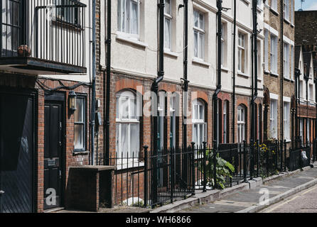 London, UK - July 18, 2019: Row of traditional English houses on a residential street in Marylebone, a chic residential area of London famous for bake Stock Photo