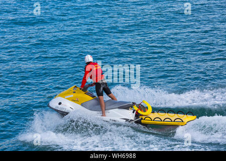 RNLI Lifeguard on jetski on patrol at Bournemouth beach during Bournemouth Air Festival, Dorset UK in August Stock Photo