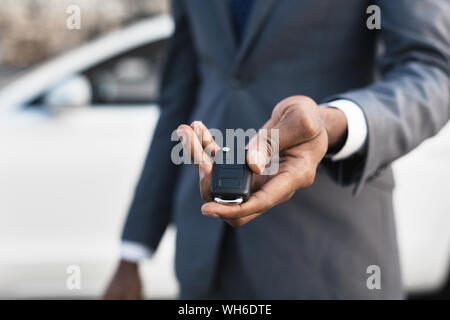 Car sale concept. Man hand giving car key Stock Photo