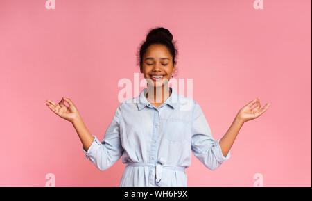 Portrait of cute teen girl holding her fingers in mudra gesture Stock Photo