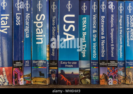 Antwerp, Belgium, September 2019, Illustrative Editorial: bunch of used Lonely Planet travel guide books in a row Stock Photo
