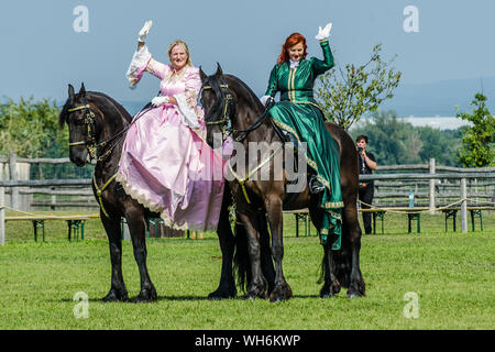 Schloss Hof Großes Pferdefest 2019 Great Equestrian Show at Schloss Hof Castle with two women riding on a side saddle Stock Photo