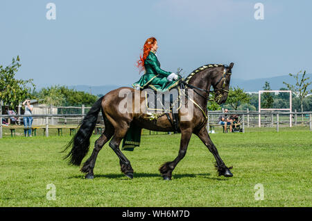 Schloss Hof Großes Pferdefest 2019 Great Equestrian Show at Schloss Hof Castle with two women riding on a side saddle Stock Photo