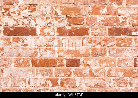 Old orange brick wall with cracks on the bricks. shabby vintage wall. Stock Photo