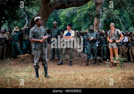 Lt Colonel Andrew Parker Bowles, centre with blue folder, at Camp Alpha, Rhodesia-Zimbabwe 1980. He is seen supervising the Patriotic Front troops coming in from the bush into British Army run holding camps in the Zambezi valley as part of the Lancaster House peace process after the Rhodesian civil war ended.  He was Senior Military Liaison Officer to Lord Soames, when he was Governor of Rhodesia during its transition to the majority rule state of Zimbabwe in 1979–1980. He was staff qualified (sq), and became a Lieutenant-Colonel 30 June 1980.AK47AK47 He was awarded the Queen's Commendation fo Stock Photo