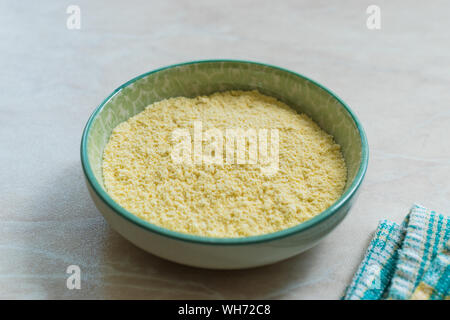 Dry Organic Corn Meal Flour in Ceramic Bowl. Ready to Use. Stock Photo