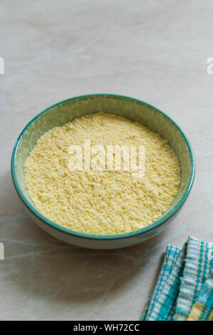 Dry Organic Corn Meal Flour in Ceramic Bowl. Ready to Use. Stock Photo