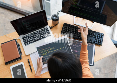 Asian team Outsource Developer Looking Screen Programming Code Working with Laptop Computer Software Stock Photo