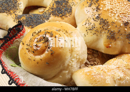Close up of home made fresh bread rolls (buns) with herbs and seeds Stock Photo
