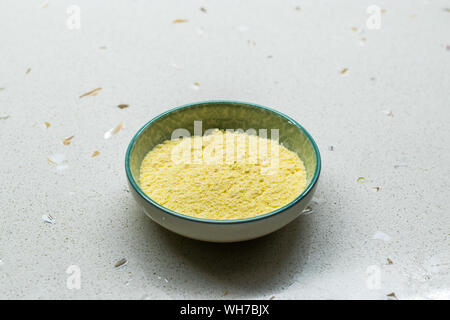 Dry Organic Corn Meal Flour in Ceramic Bowl. Ready to Use. Stock Photo