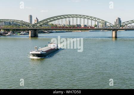 Cargo ship on the Rhine off Hohenzollern Bridge, Cologne, North Rhine-Westphalia, Germany Stock Photo