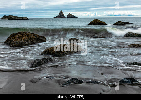 Summer waves crashing over a rocky beach in Samuel H. Boardman State Scenic Corridor, just north of Brookings, Oregon. Stock Photo