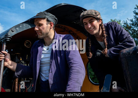 EAST GRINSTEAD, WEST SUSSEX/UK - AUGUST 30 : Fireman and stoker of steam locomotive in East Grinstead West Sussex on August 30, 2019. Two unidentified people Stock Photo