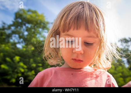3 year old child blowing bubbles Stock Photo