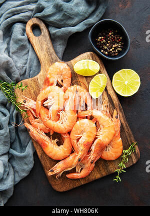 Shrimps served with lemons and spices on a black background Stock Photo