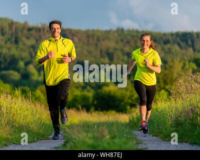 Young man and woman jogging Stock Photo