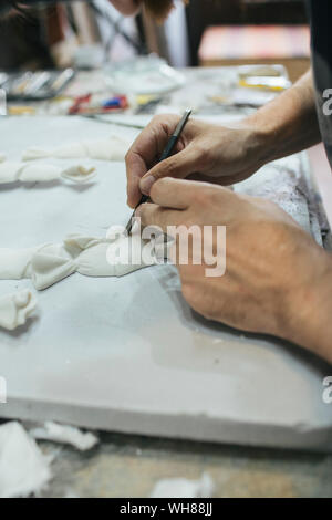 Sculptor working on an object Stock Photo