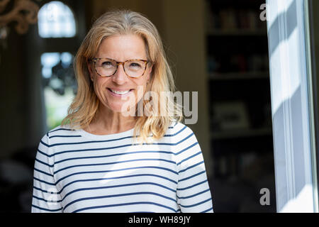 Portrait of smiling mature woman wearing glasses Stock Photo