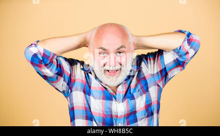 just happy. mature bearded man in checkered shirt. grandfather on retirement. happy senior man with gray beard. barber and hairdresser salon. male fashion. positive emotions. happy old grandad. Stock Photo