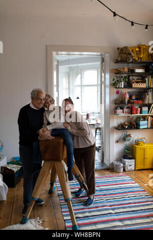 Portrait of happy grandparents with grandson at home Stock Photo