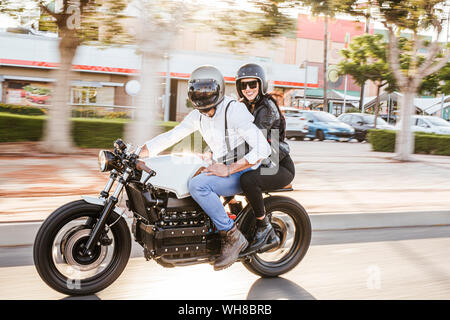 Couple riding motorbike in the city Stock Photo